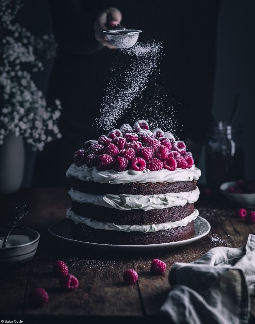 Icing sugar being dusted over Chocolate Raspberry Cake © Baiba Opule 